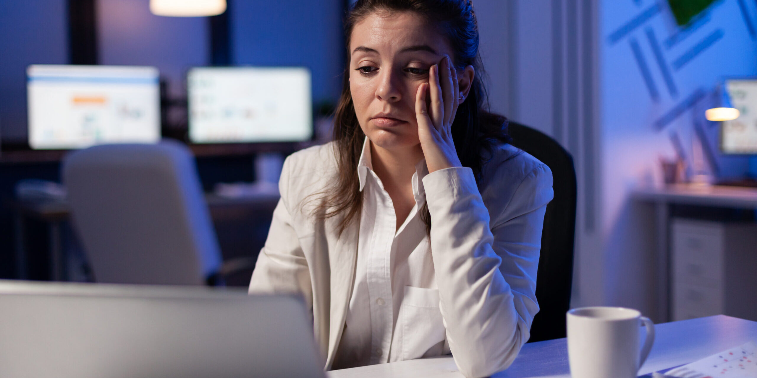 Exhausted corporate professional experiencing burnout working late showing work life balance is impossible in corporate jobs