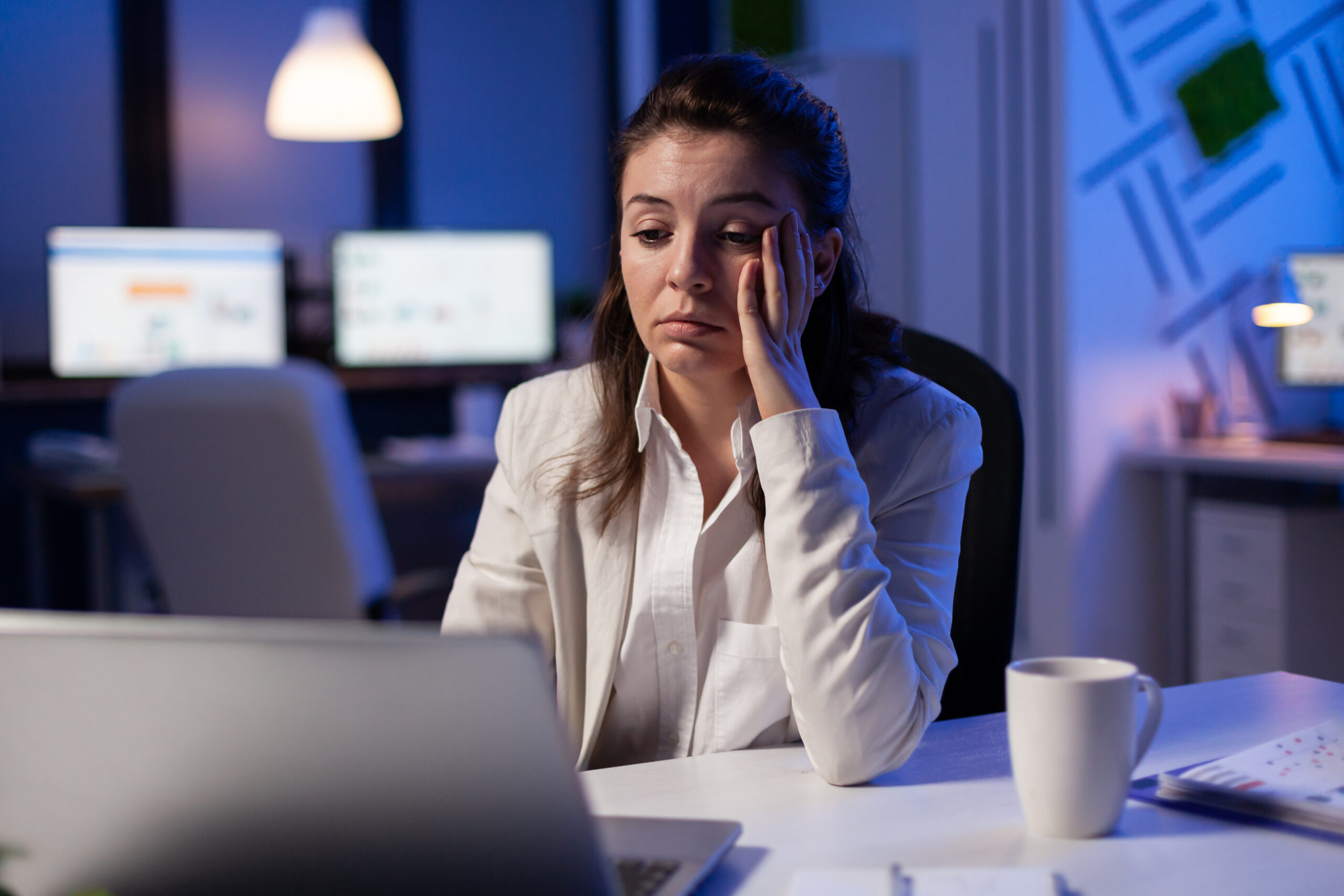 Exhausted corporate professional experiencing burnout working late showing work life balance is impossible in corporate jobs