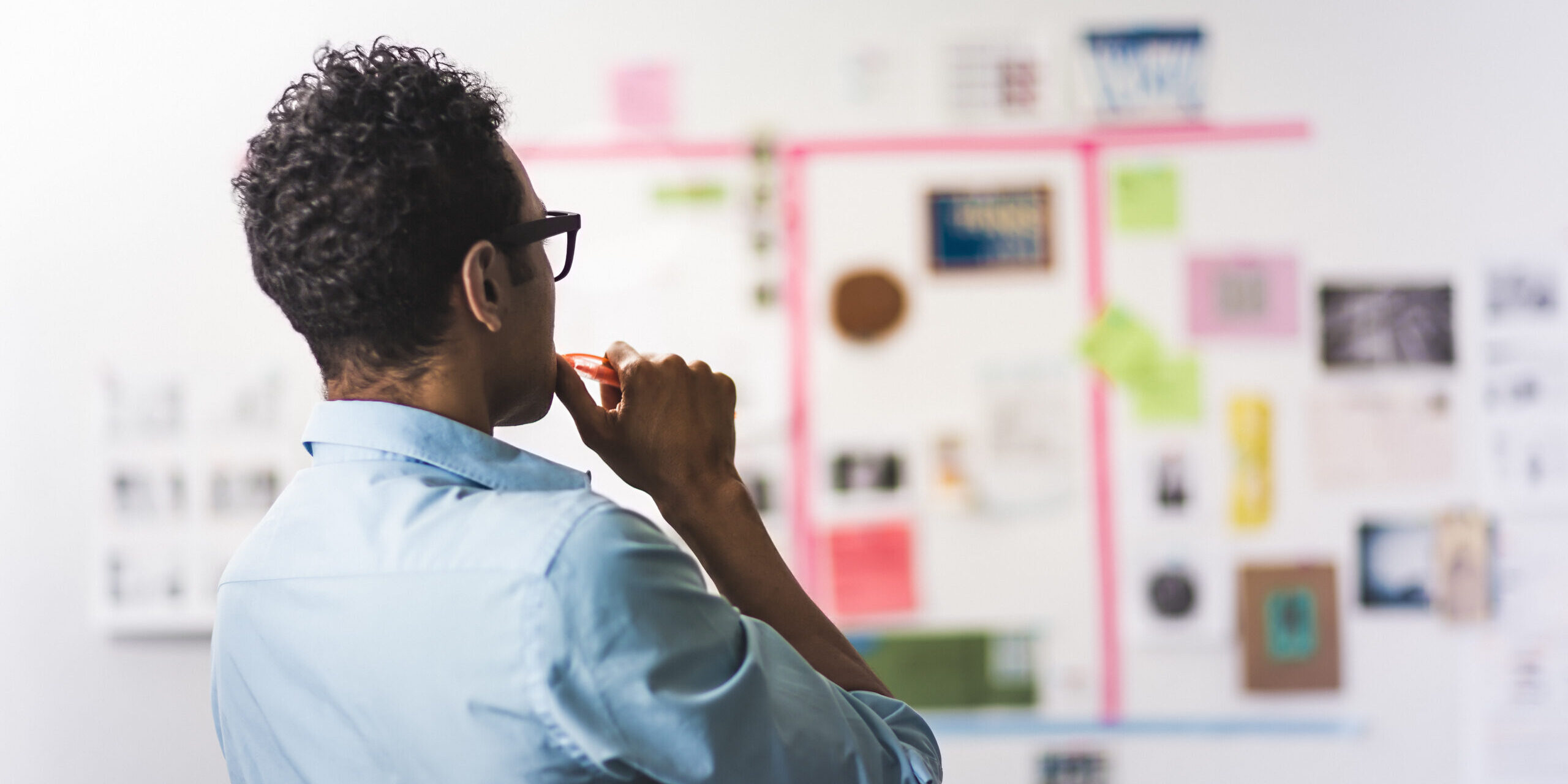 New entrepreneur planning business strategy and avoiding common startup mistakes with wall of notes